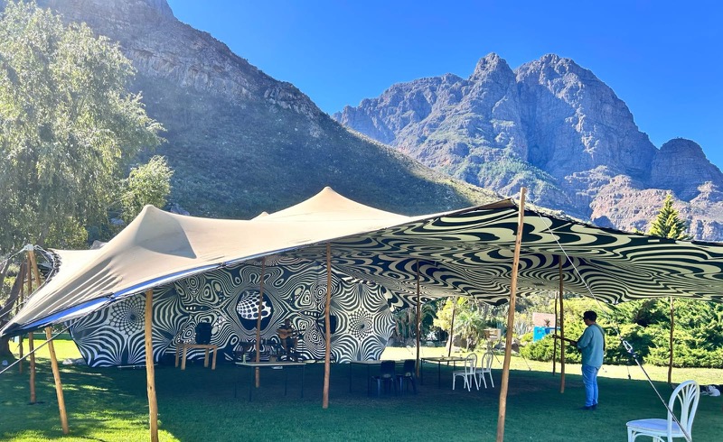 Stretch tent hire for private parties, raves and milestone celebrations — dramatic outdoor setup against a mountain backdrop