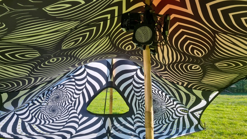 Festival stretch tent hire UK — wave-pattern canvas interior at a private outdoor festival